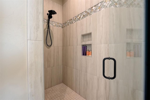 bathroom with a shower with door