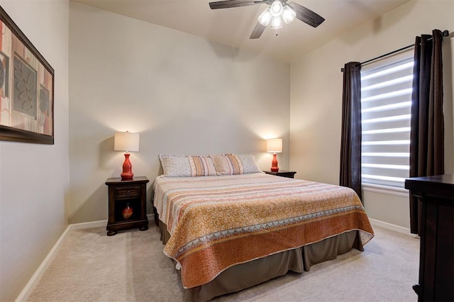 bedroom featuring light carpet and ceiling fan