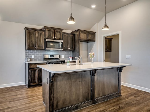 kitchen with sink, decorative light fixtures, dark brown cabinets, and stainless steel appliances