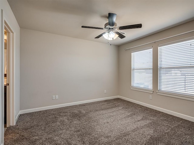 carpeted spare room featuring ceiling fan