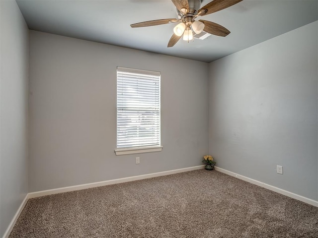 spare room featuring ceiling fan and carpet floors