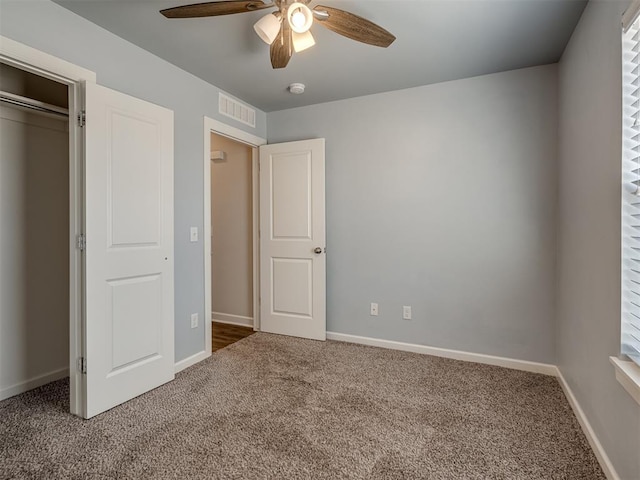 unfurnished bedroom with carpet, ceiling fan, and a closet