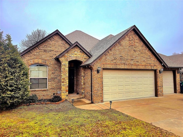 view of front of property featuring a garage and a front lawn