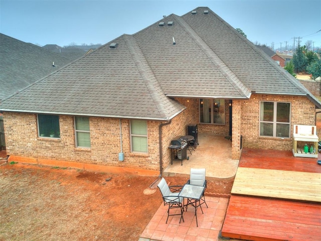 rear view of house featuring a deck