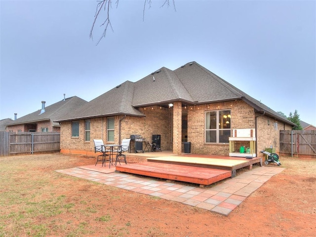 rear view of property featuring a deck