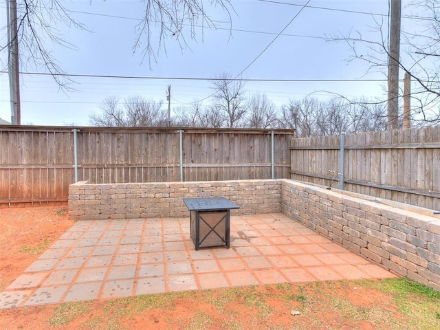 view of patio with a fire pit