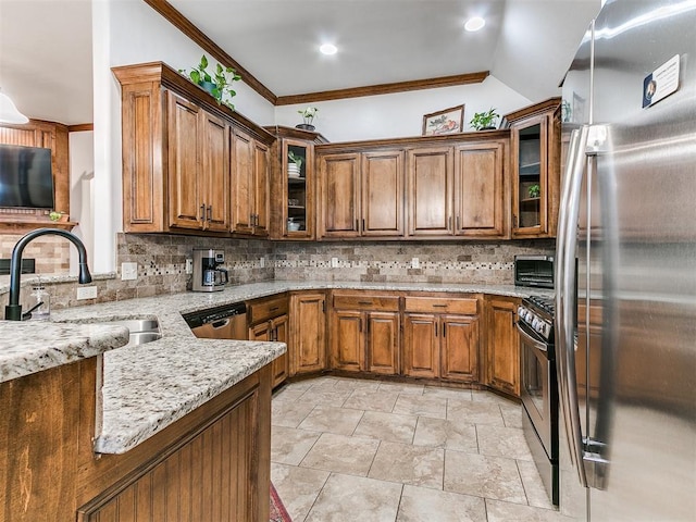 kitchen featuring sink, light stone counters, appliances with stainless steel finishes, kitchen peninsula, and backsplash