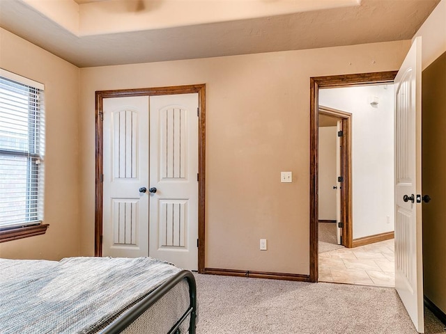 bedroom with light carpet and a closet