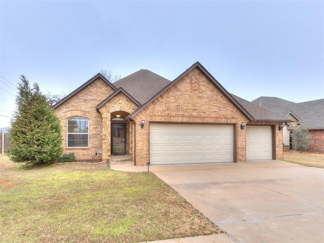 view of front facade with a garage and a front lawn