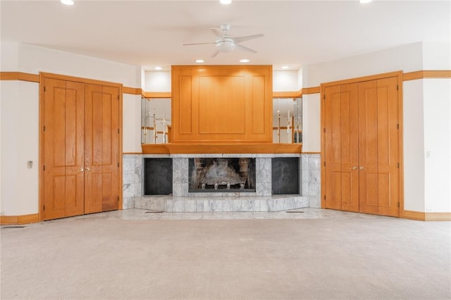 unfurnished living room with a fireplace, recessed lighting, a ceiling fan, light carpet, and baseboards