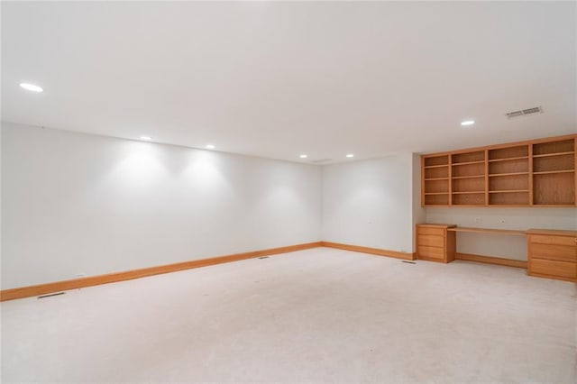 interior space featuring recessed lighting, built in study area, visible vents, and light colored carpet