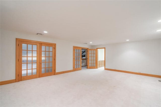 carpeted empty room with recessed lighting, baseboards, visible vents, and french doors