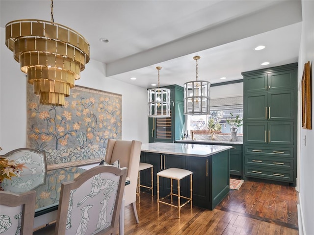 kitchen featuring a chandelier, green cabinetry, decorative light fixtures, and a center island