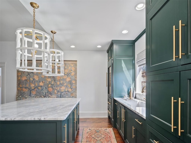 kitchen with pendant lighting, green cabinetry, an inviting chandelier, and sink