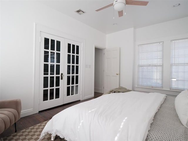 bedroom with dark hardwood / wood-style flooring, french doors, and ceiling fan