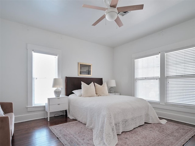 bedroom with dark wood-type flooring and ceiling fan