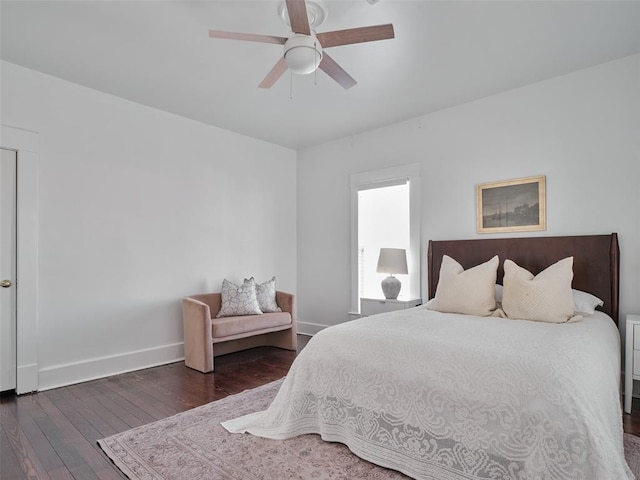 bedroom with dark hardwood / wood-style floors and ceiling fan