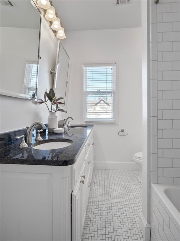 bathroom featuring vanity, tile patterned flooring, and toilet