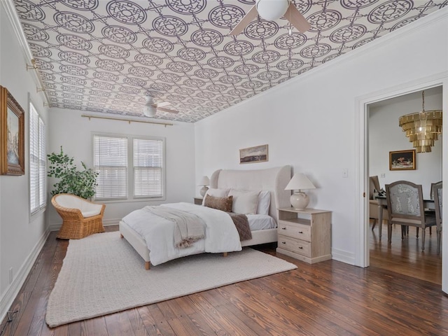 bedroom with ornamental molding and dark hardwood / wood-style floors