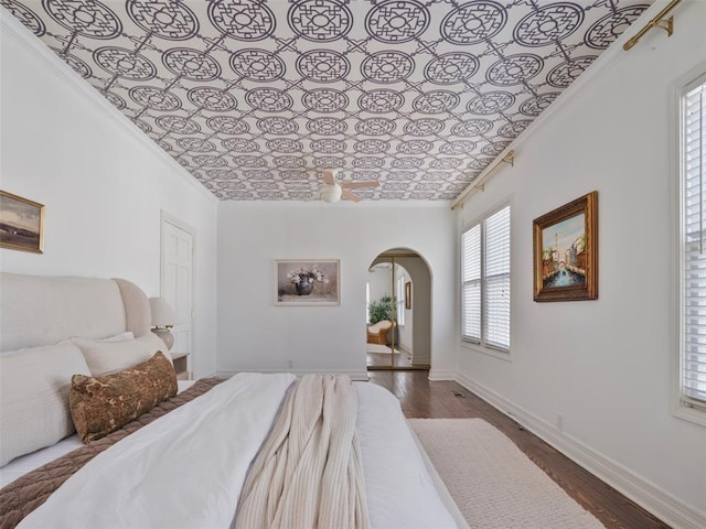 bedroom featuring crown molding and dark hardwood / wood-style flooring