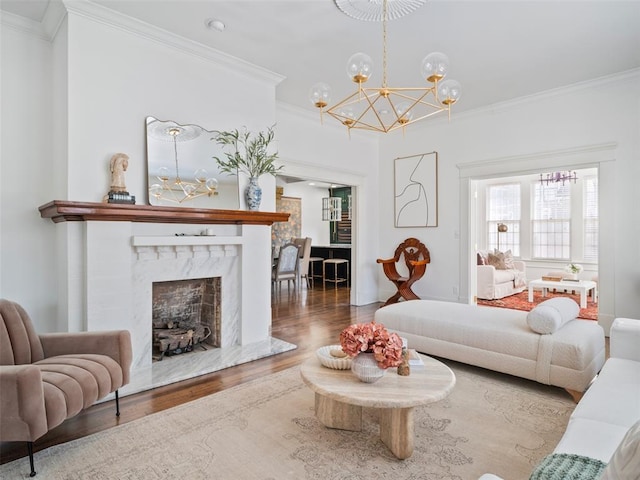 living room with ornamental molding, a fireplace, and hardwood / wood-style floors