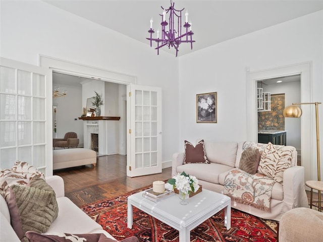 living room with dark wood-type flooring and a chandelier