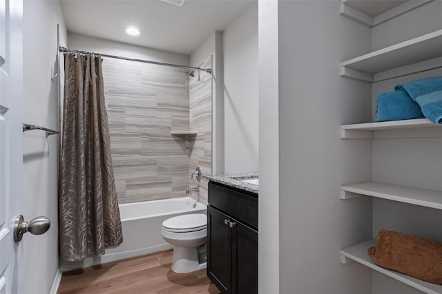 full bathroom featuring vanity, hardwood / wood-style floors, toilet, and shower / bath combo