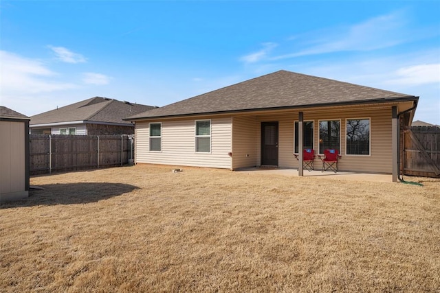 back of property featuring a lawn and a patio area