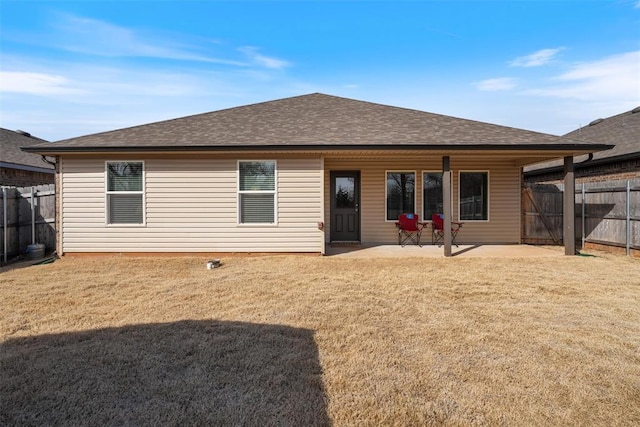 back of property featuring a patio area and a lawn