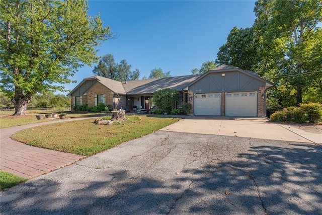 view of front of property with a garage and a front lawn