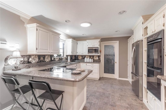 kitchen featuring white cabinetry, kitchen peninsula, and black appliances