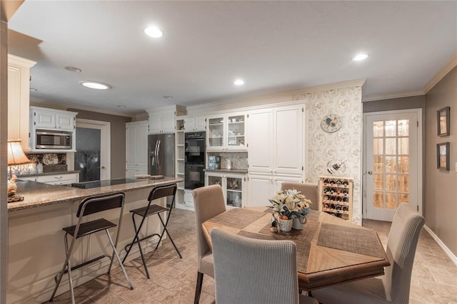 dining space with crown molding