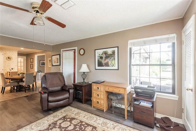 home office with crown molding, ceiling fan, hardwood / wood-style flooring, and a textured ceiling