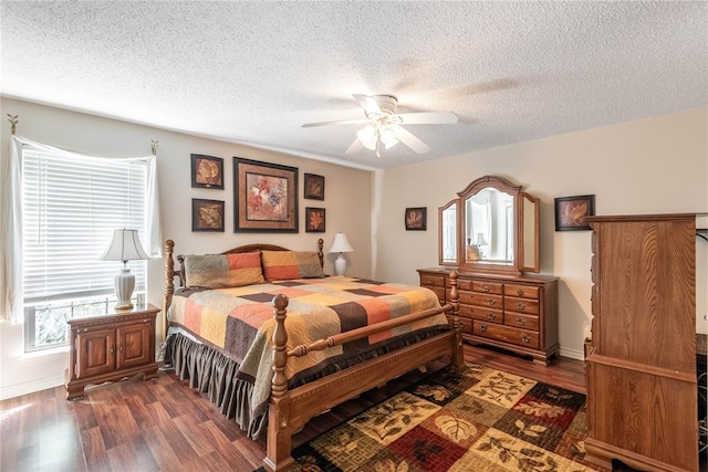 bedroom featuring ceiling fan, dark hardwood / wood-style floors, and a textured ceiling