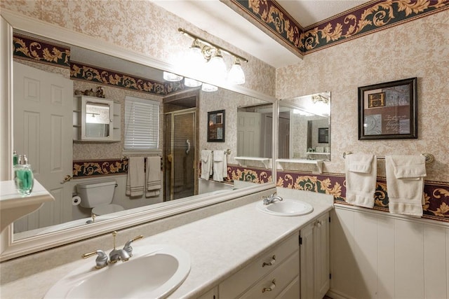 bathroom featuring vanity, toilet, and an enclosed shower