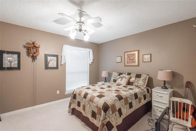 carpeted bedroom with ceiling fan and a textured ceiling