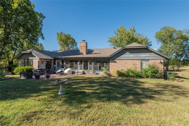 back of property featuring a patio and a yard