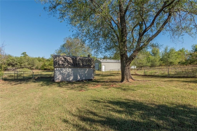 view of yard with a rural view and a storage unit