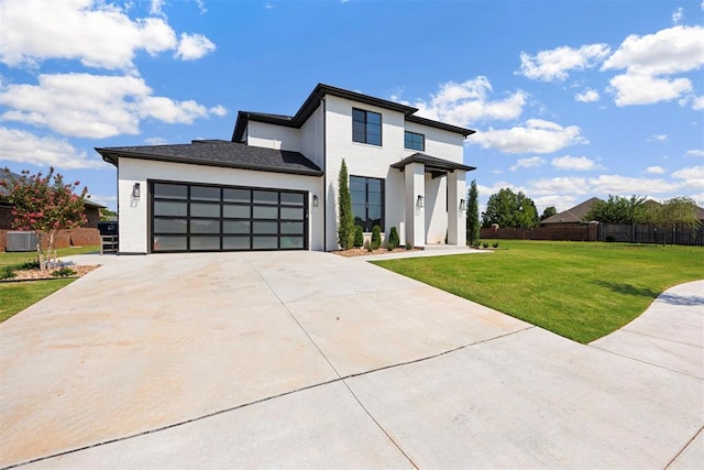 contemporary house featuring a garage, concrete driveway, fence, cooling unit, and a front yard