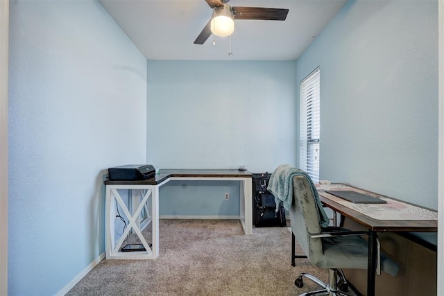 carpeted office space with ceiling fan