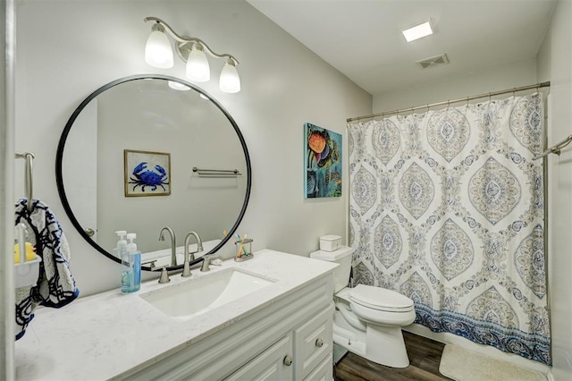 bathroom with wood-type flooring, curtained shower, vanity, and toilet