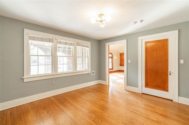 spare room with light hardwood / wood-style flooring