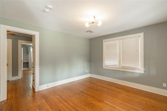 empty room with hardwood / wood-style flooring