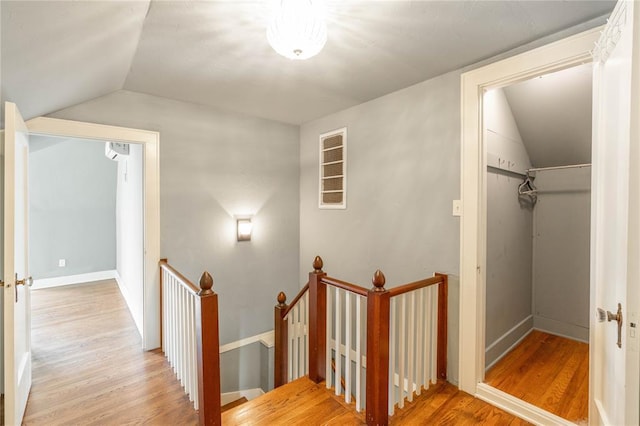 stairs featuring lofted ceiling and wood-type flooring