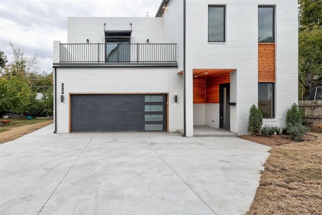 view of front of property with a balcony and a garage