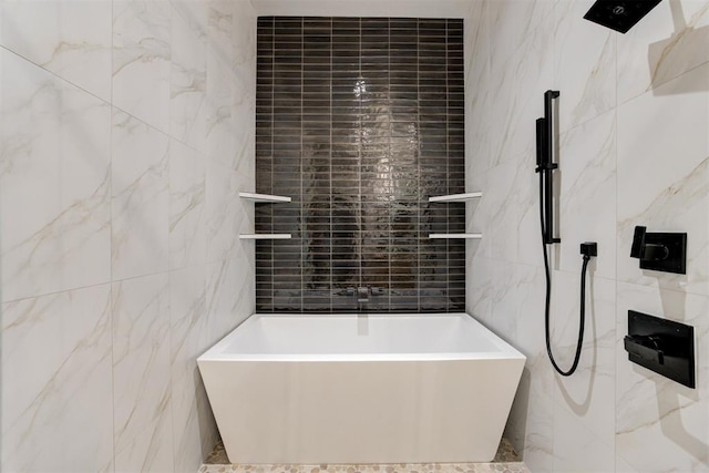 bathroom featuring tile walls and a tub to relax in