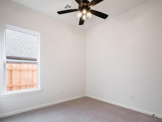 spare room featuring ceiling fan, carpet floors, visible vents, and baseboards