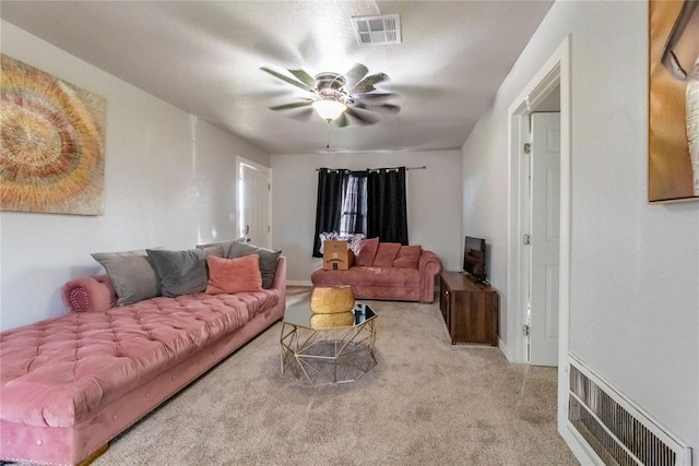 living room with light carpet and ceiling fan