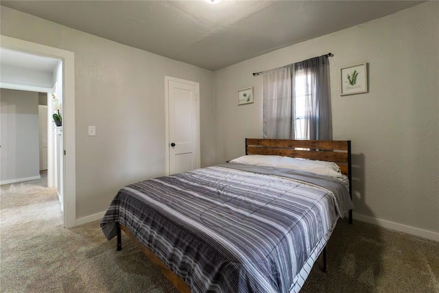 bedroom with dark colored carpet