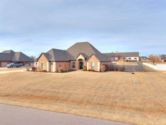 french provincial home with a front yard